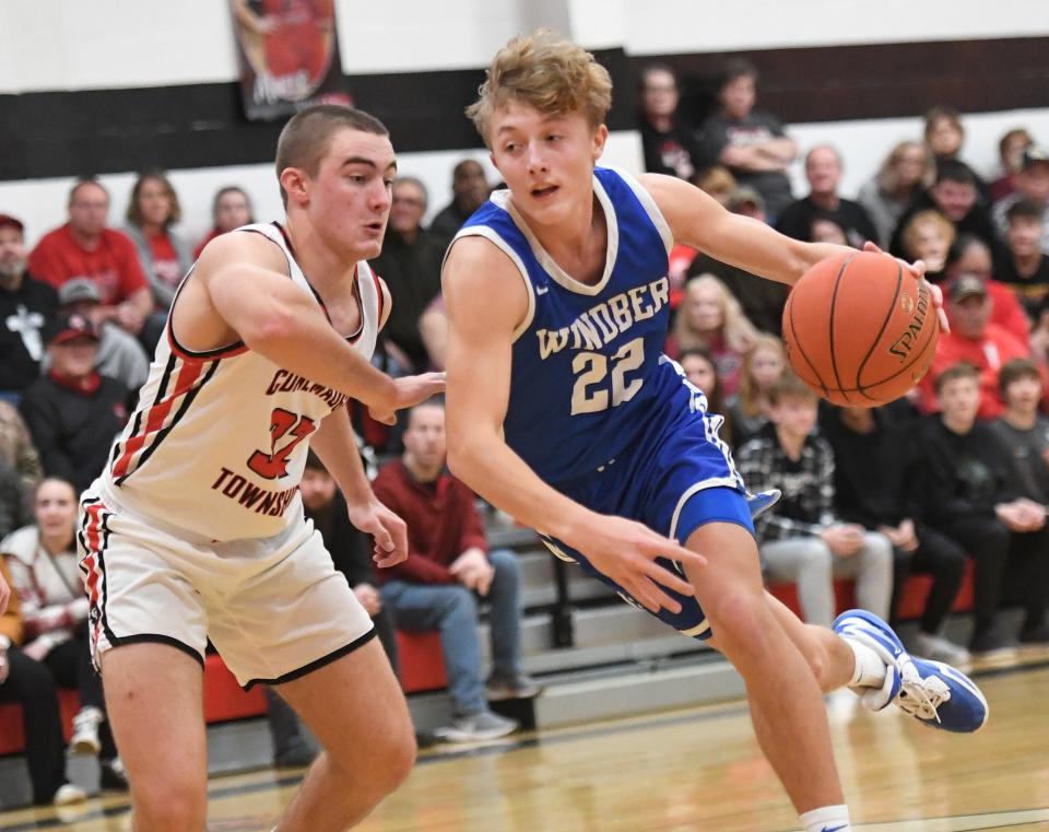 Windber's Grady Klosky (22) drives the lane against Conemaugh Township's Trent Brenneman during a boys WestPAC basketball contest, Jan. 5, in Davidsville.