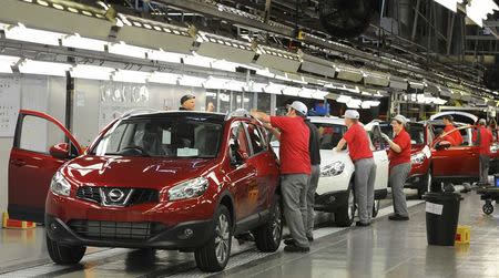 A worker is seen completing final checks on the production line at Nissan car plant in Sunderland, northern England, June 24, 2010. REUTERS/Nigel Roddis/Files