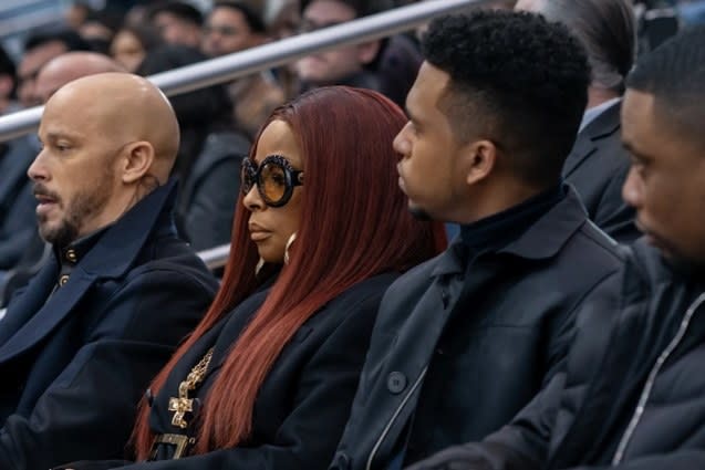 Group, including Monet, sitting in stands