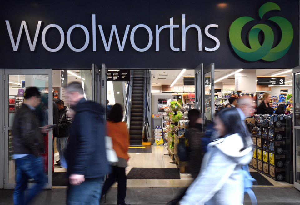 Pedestrians walk pass a Woolworths store in Sydney. Source: AAP