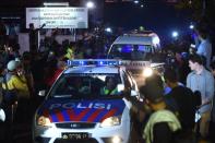 A police car escorts an ambulance carrying a coffin bearing the body of one of the drug convicts after execution at Nusakambangan port in Cilacap, on April 29, 2015