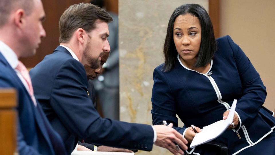 PHOTO: FILE - Fulton County District Attorney Fani Willis, talks with a member of her team in Fulton County, Ga., May 2, 2022. (Ben Gray/AP, FILE)