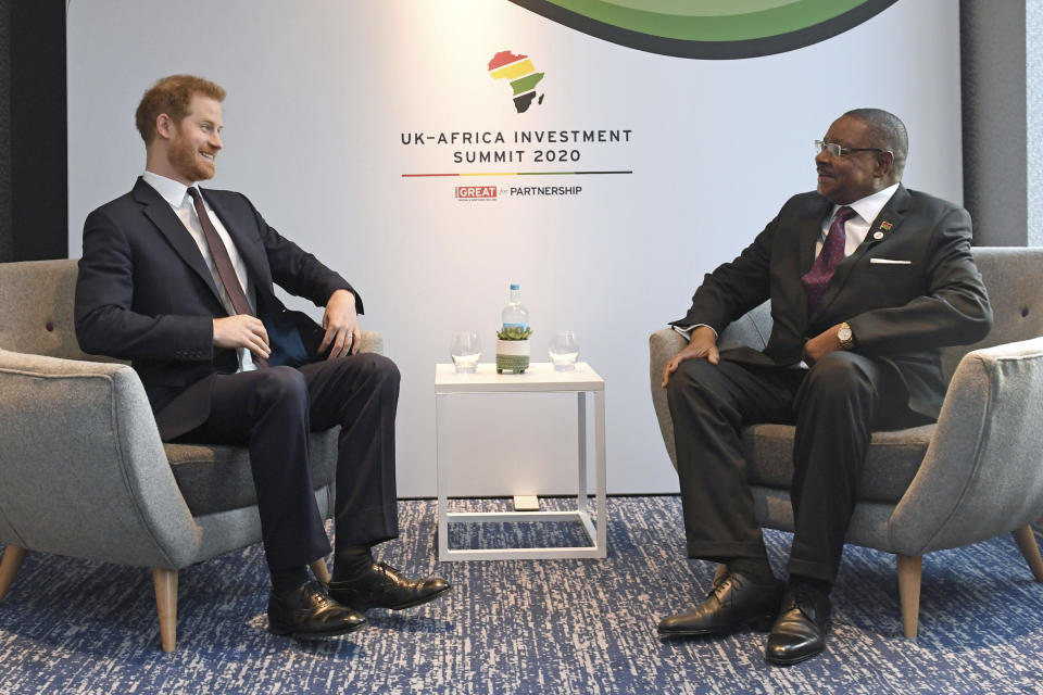 Britain's Prince Harry meets with President of Malawi, Arthur Peter Mutharika, right, at the UK Africa Investment Summit in London, Monday Jan. 20, 2020. Britain's Prime Minister Boris Johnson is hosting 54 African heads of state or government in London, as the U.K. prepares for post-Brexit dealings with the world. (Stefan Rousseau/Pool via AP)