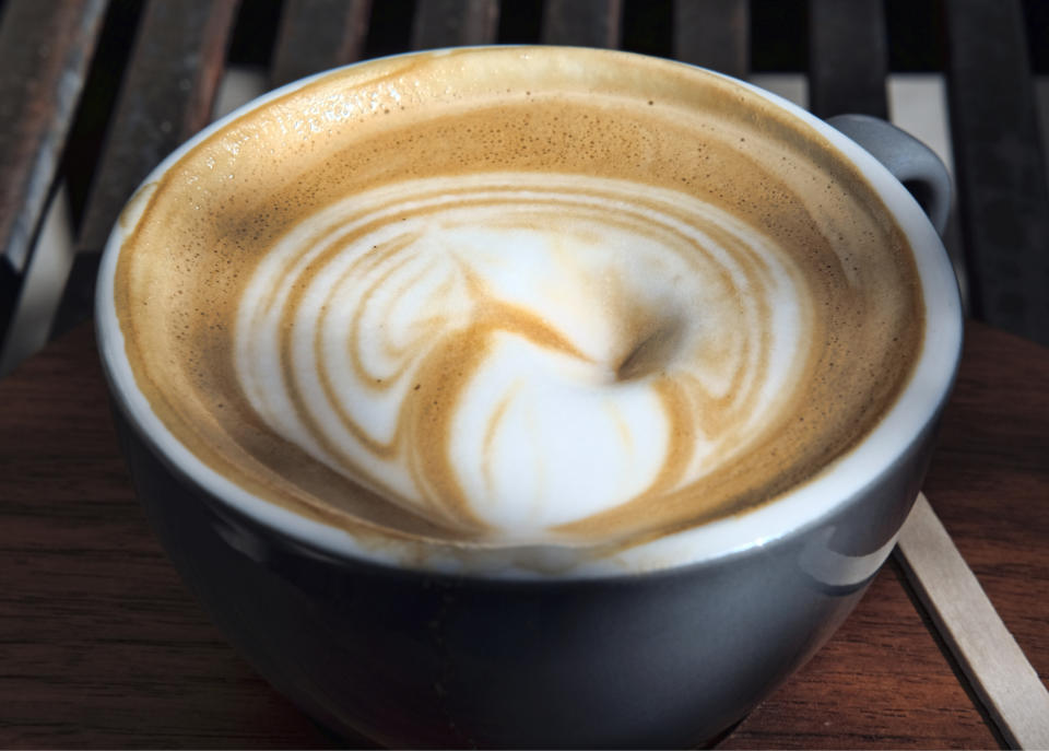 FILE - This March 29, 2018 file photo shows steamed milk floating atop a cup of coffee at a cafe in Los Angeles. California has officially concluded coffee does not pose a "significant" cancer risk. State regulators gave final approval Monday, June 3, 2019 to a rule that means coffee won't have to carry ominous warnings that the beverage may be bad for you. (AP Photo/Richard Vogel, File)
