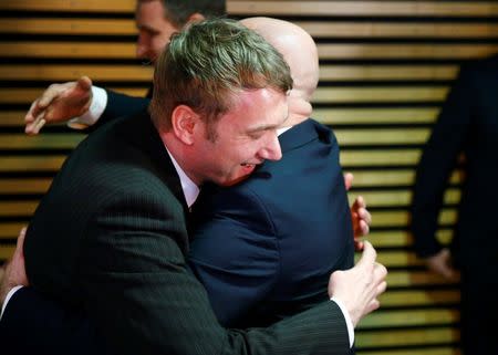 Andreas Kalbitz (R) congratulates Andre Poggenburg of the anti-immigration Alternative for Germany (AfD) party after the first local elections polls in Magdeburg, Germany March 13, 2016. REUTERS/Wolfgang Rattay