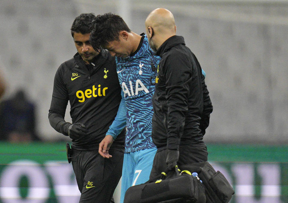 FILE - Tottenham's Son Heung-min leaves the field injured during the Champions League Group D soccer match between Marseille and Tottenham Hotspur at the Stade Velodrome in Marseille, France, Tuesday, Nov. 1, 2022. When Son Heung-min went down clutching his face in Tottenham’s Champions League match with Marseille last week the pain was not confined to his fractured eye socket. The shockwaves were felt all the way back in his homeland South Korea as the nation feared the worst ahead of the World Cup. (AP Photo/Daniel Cole, File)