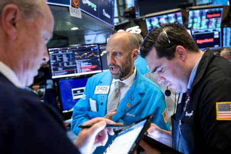 Traders work on the floor at the NYSE in New York