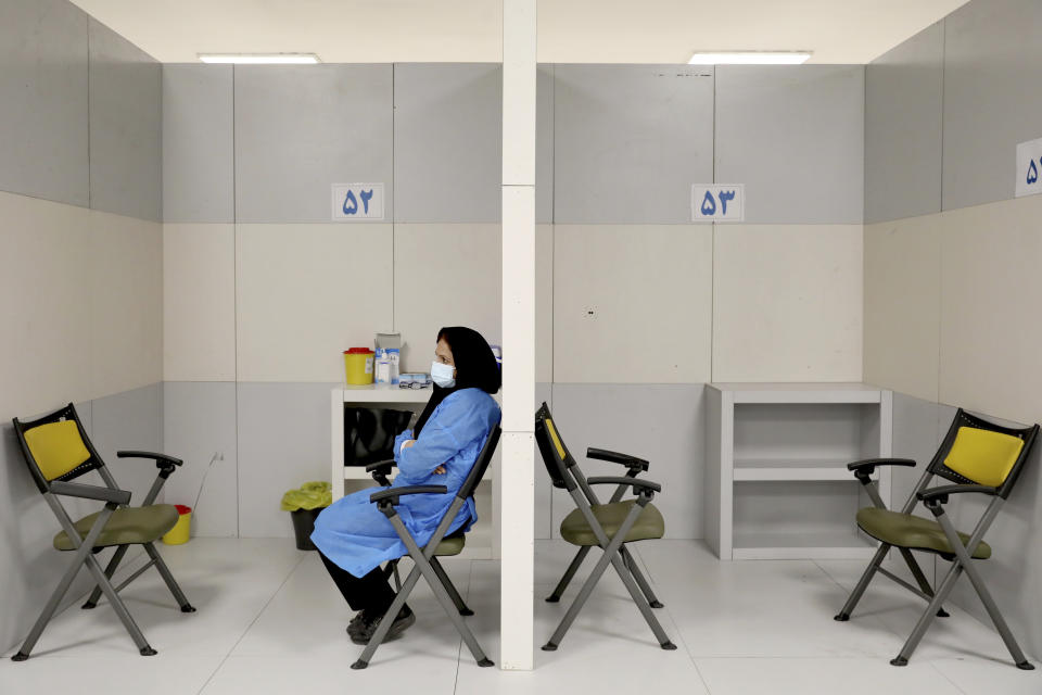 A medic waits to administer Sinopharm COVID-19 vaccine shots, at the Iran Mall shopping center in Tehran, Iran, Monday, May 17, 2021. (AP Photo/Ebrahim Noroozi)