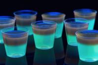 <p>Even when you're in disguise, your friends won't be able to loose you with these glow-in-the-dark layered shots.</p><p>Get the <a href="https://www.delish.com/cooking/recipe-ideas/recipes/a44347/glowing-jell-o-shots-glow-party-foods/" rel="nofollow noopener" target="_blank" data-ylk="slk:Glowing Jello Shots recipe;elm:context_link;itc:0;sec:content-canvas" class="link "><strong>Glowing Jello Shots recipe</strong></a> from Delish. </p>