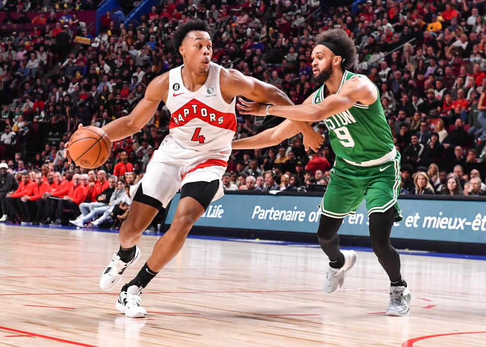 MONTREAL, CANADA - OCTOBER 14:  Scottie Barnes #4 of the Toronto Raptors dribbles the ball against Derrick White #9 of the Boston Celtics during the first half of a preseason NBA game at Centre Bell on October 14, 2022 in Montreal, Quebec, Canada.  The Toronto Raptors defeated the Boston Celtics 137-134 in overtime.  NOTE TO USER: User expressly acknowledges and agrees that, by downloading and or using this photograph, User is consenting to the terms and conditions of the Getty Images License Agreement.  (Photo by Minas Panagiotakis/Getty Images)