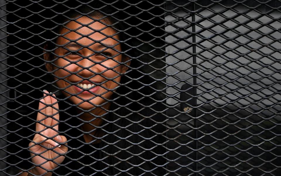 One of Thailand's protest leaders, Patsaravalee "Mind" Tanakitvibulpon arrives at court after she was arrested