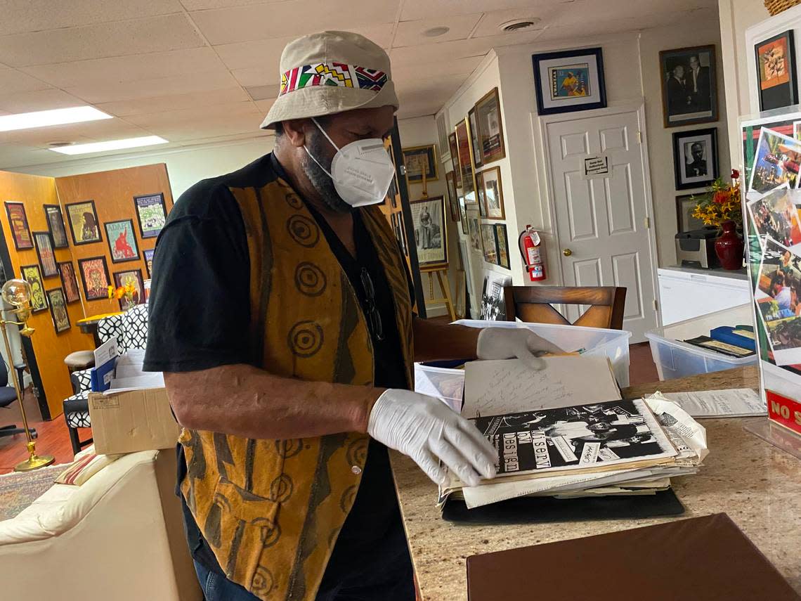 Angaza Laughinghouse, 71, a labor organizer and founding member of Black Workers for Justice, flips through his organization’s archives in Raleigh.