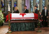 The wife of Canada's former finance minister Jim Flaherty, Christine Elliott (L) and his sons Quinn (C), John and Galen (R) walk past his casket at his state funeral in Toronto, April 16, 2014. REUTERS/Mark Blinch (CANADA - Tags: POLITICS OBITUARY)