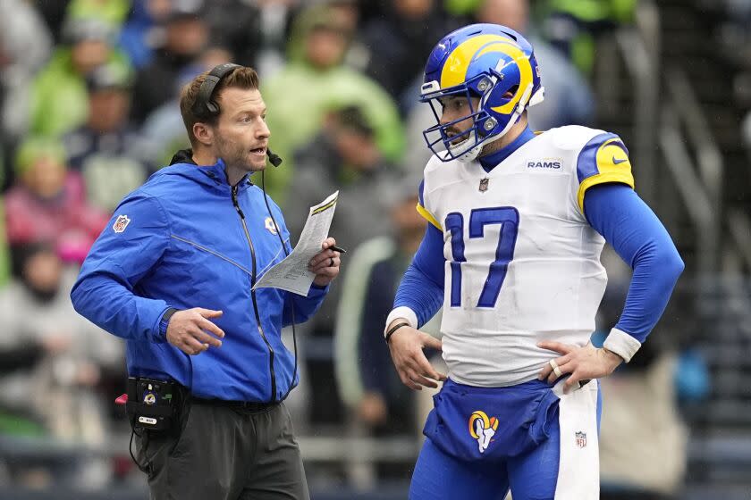 Los Angeles Rams head coach Sean McVay, left, talks to quarterback Baker Mayfield.