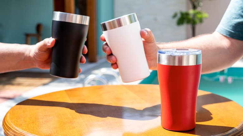 three different travel mugs