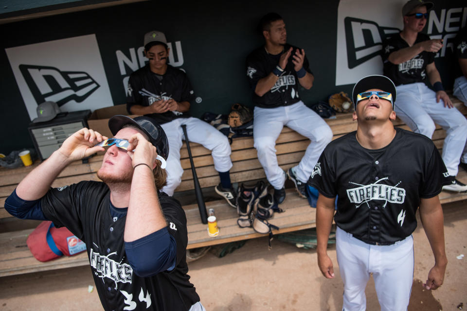 COLUMBIA, SC - AUGUST 21: Minor league baseball players Dash Winningham (34) and Justin Brantley (4), with the Columbia Fireflies, watch a solar eclipse at Spirit Communications Park August 21, 2017 in Columbia, South Carolina.   / Credit: Sean Rayford/Getty Images