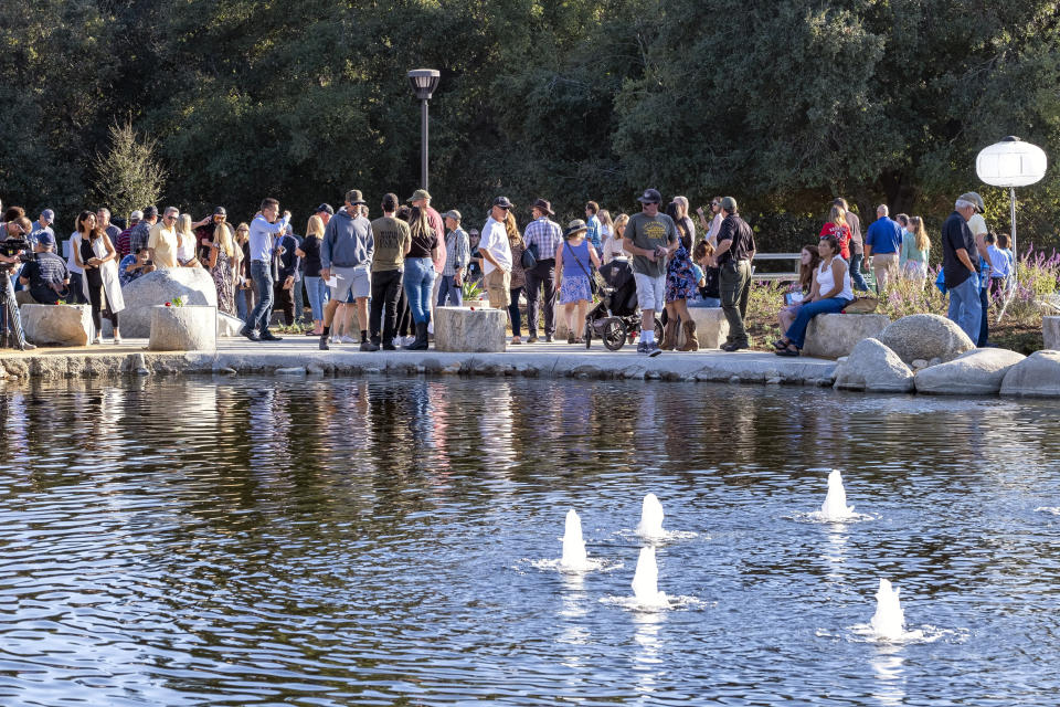 People look at the Borderline Healing Garden at Conejo Creek Park in Thousand Oaks, Calif., Thursday, Nov. 7, 2019. The dedication marked the anniversary of a fatal mass shooting at a country-western bar a year earlier. (Hans Gutknecht/The Orange County Register via AP)