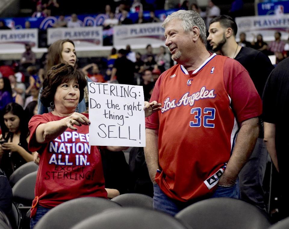 A fan holds up a sign about Los Angeles Clippers owner Donald Sterling before Game 5 of the Clippers' opening-round NBA basketball playoff series against the Golden State Warriors on Tuesday, April 29, 2014, in Los Angeles. NBA Commissioner Adam Silver announced Tuesday that Sterling has been banned for life by the league for making racist comments that hurt the league. (AP Photo)