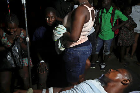 People injured in an earthquake that hit northern Haiti late on Saturday, gather in the patio of a hospital, in Port-de-Paix, Haiti, October 7, 2018. REUTERS/Ricardo Rojas