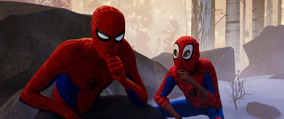 Peter Parker (Jake Johnson, left) is a heroic role model to Miles Morales (Shameik Moore) in "Spider-Man: Into the Spider-Verse."