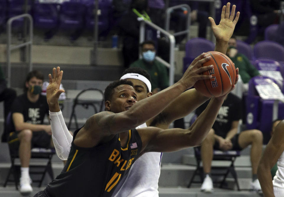Baylor guard Mark Vital (11) tries to put up a shot past TCU forward Kevin Easley (34) in the second half of an NCAA college basketball game, Saturday, Jan. 9, 2021, in Fort Worth, Texas. (AP Photo/ Richard W. Rodriguez)