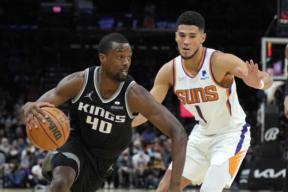 Sacramento Kings forward Harrison Barnes (40) drives past Phoenix Suns guard Devin Booker during the first half of an NBA basketball game, Wednesday, Oct. 27, 2021, in Phoenix. (AP Photo/Rick Scuteri)