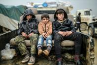 Referee children sit in a pickup on February 6, 2016 in Bab-Al Salam