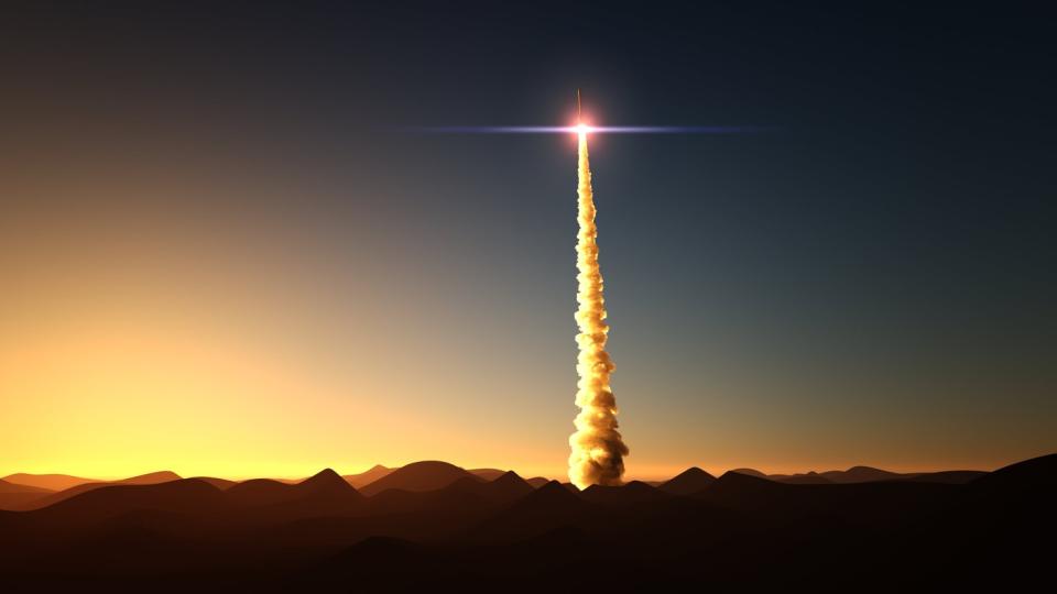 A rocket launch taking place in the desert.