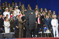 In this photo released by China's Xinhua News Agency, security personnel surround Venezuela's President Nicolas Maduro during an incident as he was giving a speech in Caracas, Venezuela, Saturday, Aug. 4, 2018. Drones armed with explosives detonated near Venezuelan President Nicolas Maduro as he gave a speech to hundreds of soldiers in Caracas on Saturday but the socialist leader was unharmed, according to the government. (Xinhua via AP)