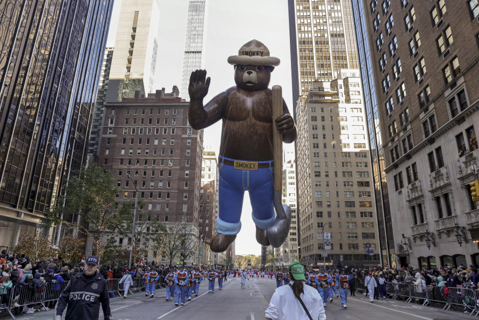 Handlers pull the Smokey Bear balloon down Sixth Avenue during the Macy's Thanksgiving Day Parade, Thursday, Nov. 24, 2022, in New York. (AP Photo/Jeenah Moon)