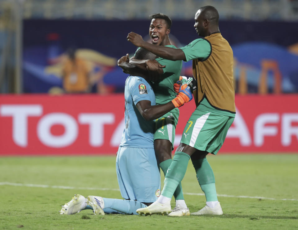 Senegal players celebrate after the African Cup of Nations semifinal soccer match between Senegal and Tunisia in 30 June stadium in Cairo, Egypt, Sunday, July 14, 2019. (AP Photo/Hassan Ammar)