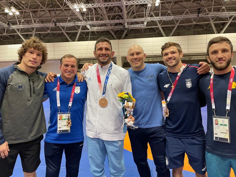 Myles Amine (wearing white) won a bronze medal a the 2020 Olympic Games on Thursday morning in Tokyo. Amine, an All-American wrestler for Michigan, went 3-1 at 86 kilograms (189 pounds) while representing San Marino. He is San Marino's first-ever Olympic wrestling medalist.