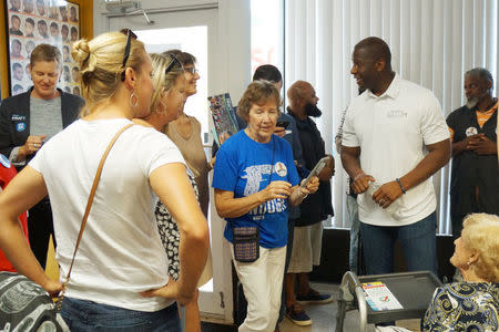 Candidate Andrew Gillum who is seeking the Democratic nomination for Florida governor, speaks to voters on a tour of barbershops in Sarasota, Florida, U.S., July 18, 2018. REUTERS/Letitia Stein