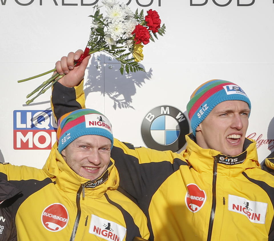 Germany's Francesco Friedrich, left, and Thorsten Margis, celebrate their win at the men's World Cup bobsled event in Calgary, Alberta, Saturday, Feb. 23, 2019. (Jeff McIntosh/The Canadian Press via AP)