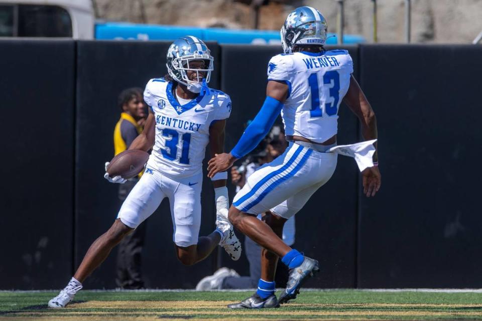 Kentucky’s Maxwell Hairston (31) celebrates with teammate J.J. Weaver (13) after returning an interception for a touchdown at FirstBank Stadium in Nashville on Saturday. Ryan C. Hermens/rhermens@herald-leader.com