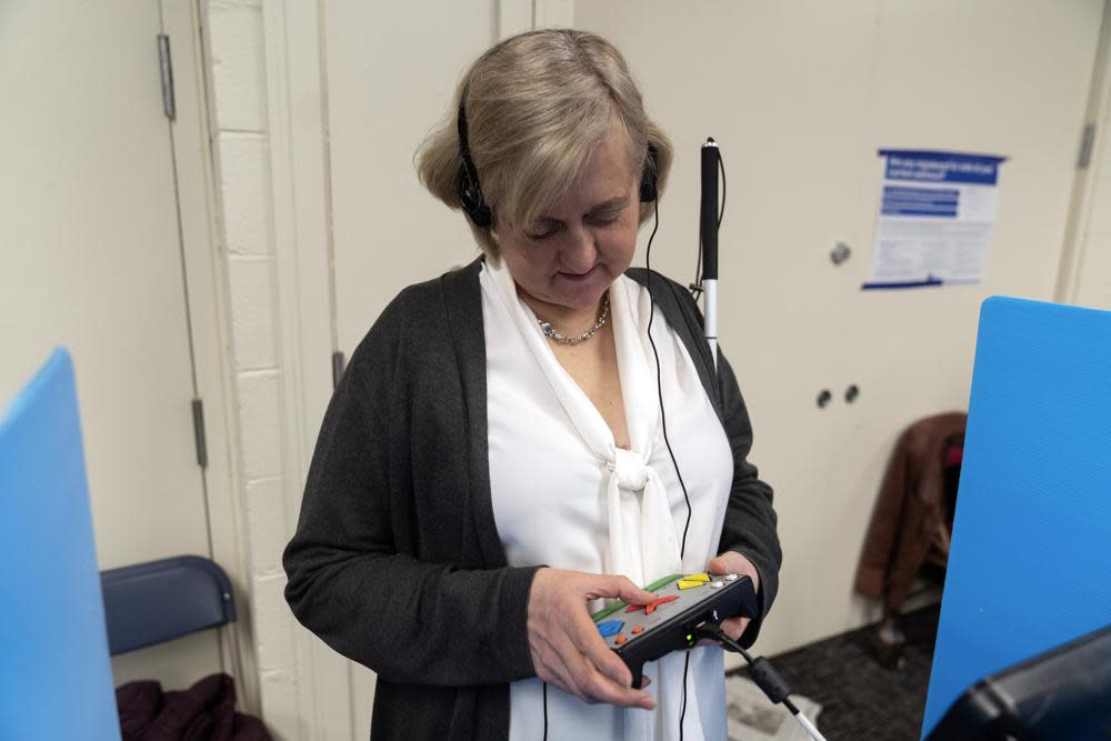 Patti Chang, who is blind, uses headphones and audio along with an electronic controller outfitted with braille to vote in the Chicago mayoral runoff election at the Roden Branch of the Chicago Public Library Wednesday, March 22, 2023, in Chicago. AP Photo Erin Hooley)