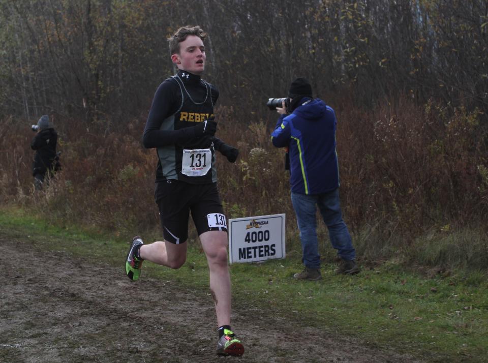 Lakeland/Panas's Bobby Mayclim passes the 4,000-meter mark during the boys Class A state cross-country championship Nov. 11, 2023 in Verona, New York.