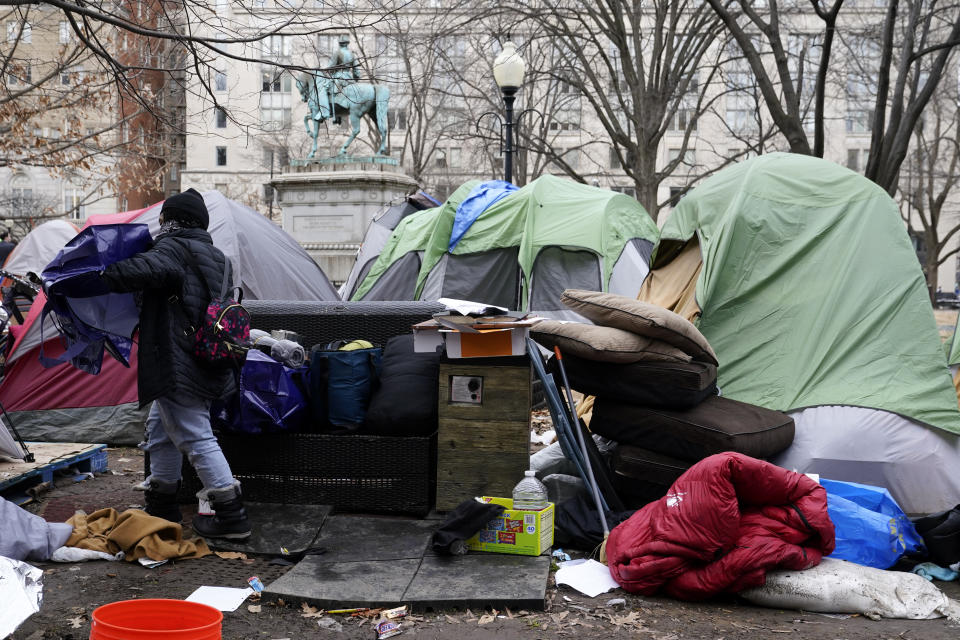 A woman walks past tents in a homeless encampment at McPherson Square in Washington, Wednesday, Feb. 15, 2023, prior to being cleared by the National Park Service. (AP Photo/Patrick Semansky)