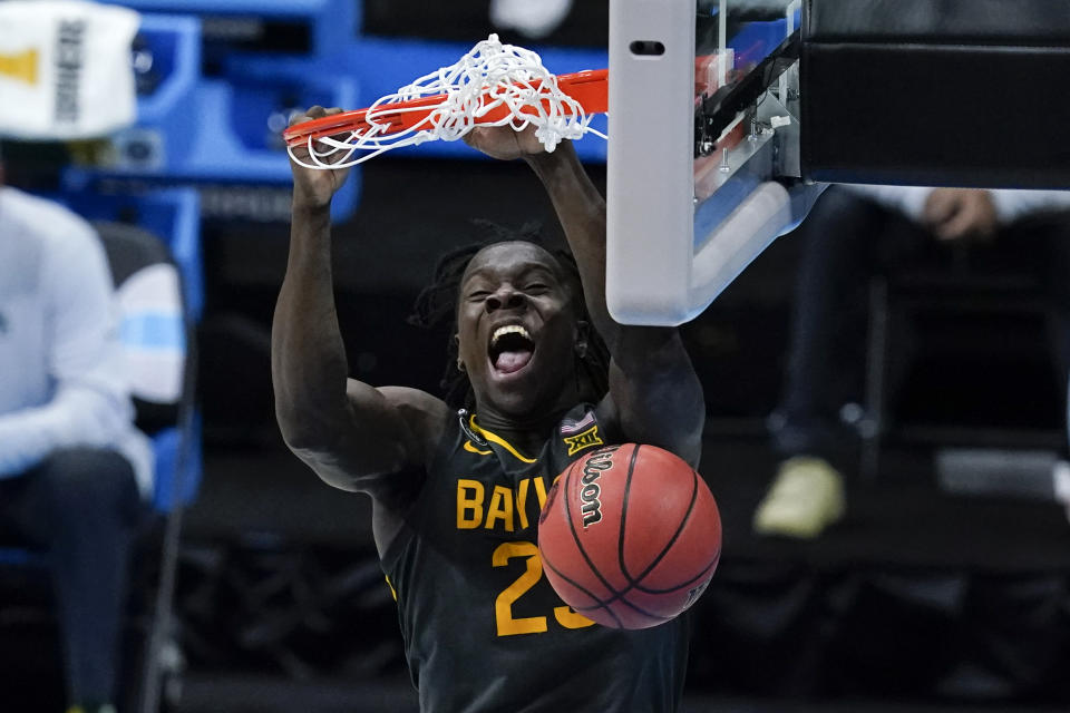 FILE - Baylor forward Jonathan Tchamwa Tchatchoua (23) dunks the ball against Gonzaga during the second half of the championship game in the men's Final Four NCAA college basketball tournament, Monday, April 5, 2021, at Lucas Oil Stadium in Indianapolis. College basketball is undergoing a shift, a new era ushered in by the transfer portal, NIL and conference realignment. Programs like Baylor and Virginia have won national championships. Upsets have become more commonplace in the NCAA Tournament. Even The Associated Press poll has been affected.(AP Photo/Darron Cummings, File)