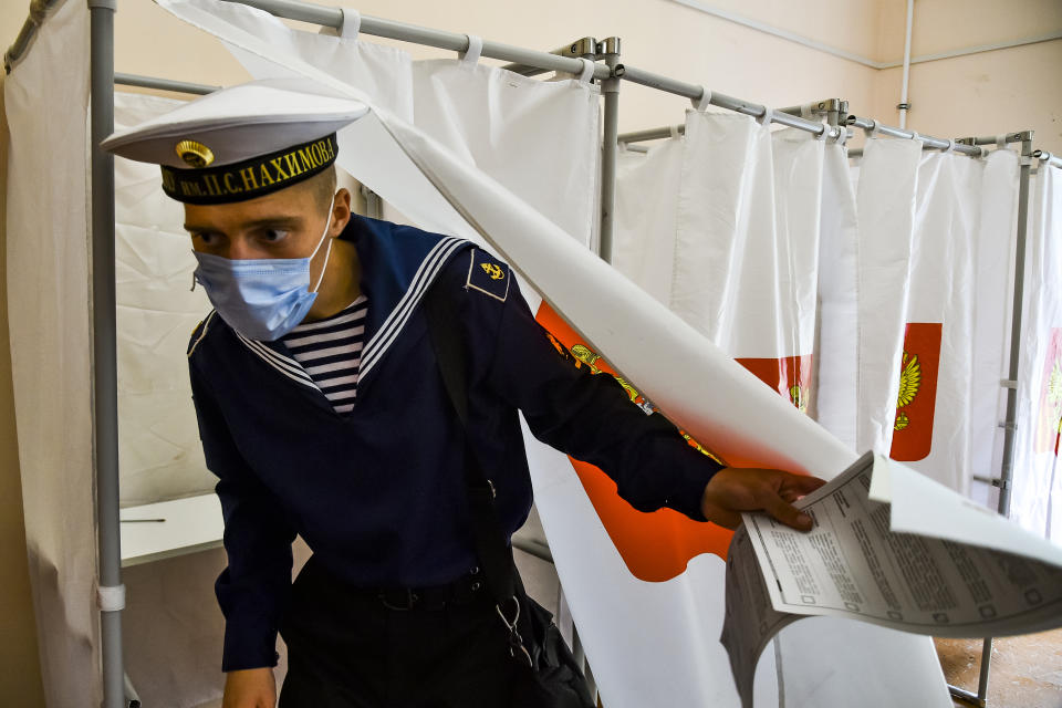 A Russian military sailor leaves a voting booth at a polling station during the Parliamentary elections in Sevastopol, Crimea, Sunday, Sept. 19, 2021. The head of Russia's Communist Party, the country's second-largest political party, is alleging widespread violations in the election for a new national parliament in which his party is widely expected to gain seats. (AP Photo)