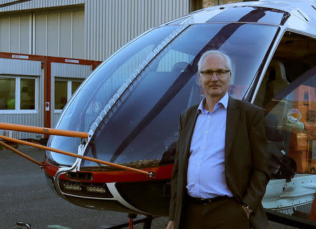 Chief Executive Andreas Loewenstein of Swiss helicopter manufacturer Marenco stands in front of a prototype of a Marenco SH09 helicopter at the company's plant in Mollis, Switzerland October 13, 2017. REUTERS/Arnd Wiegmann