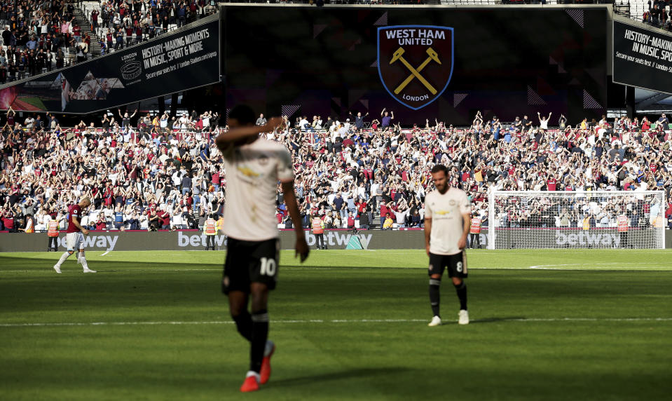 Manchester United's Marcus Rashford, left, and Manchester United's Juan Mata, right, walk off the pitch after the English Premier League soccer match between West Ham United and Manchester United at London Stadium in London in London, England, Saturday, Sept. 29, 2018. (AP Photo/Tim Ireland)