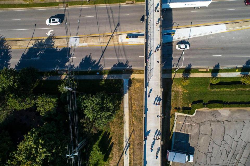 Pedestrians and cyclists cross the Brighton Rail Trail pedestrian bridge over Man O’ War Boulevard in Lexington, Ky., on Monday, Sept. 27, 2021.