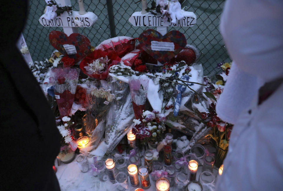 Family, friends and community members attend a vigil Sunday, Feb. 17, 2019, in Aurora, Ill., near Henry Pratt Co. manufacturing company where several were killed on Friday. Authorities say an initial background check five years ago failed to flag an out-of-state felony conviction that would have prevented a man from buying the gun he used in the mass shooting in Aurora. (AP Photo/Nam Y. Huh)