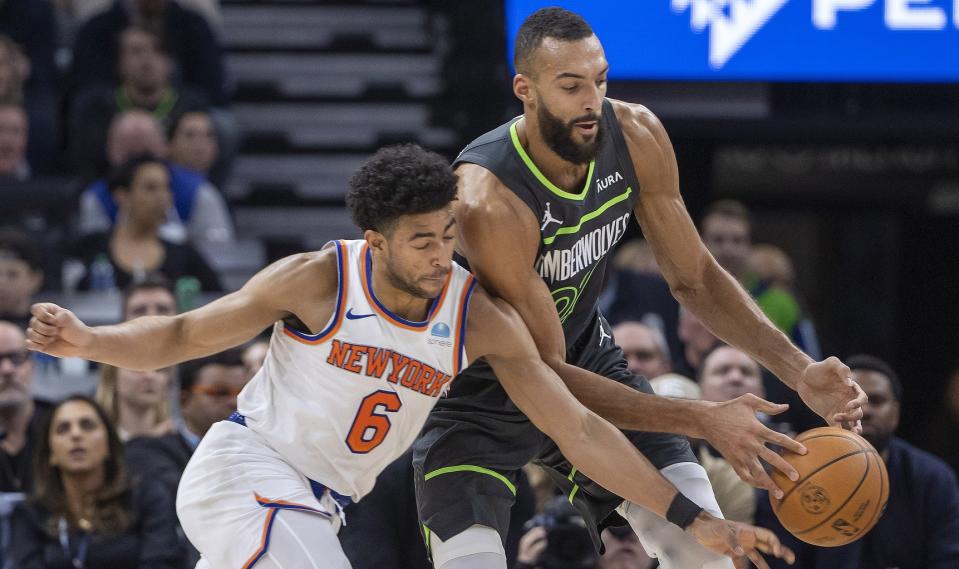 New York Knicks guard Quentin Grimes (6) and Minnesota Timberwolves center Rudy Gobert (27) go after a loose ball in the first half at Target Center.