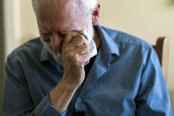 Jim Carpenter wipes tears while quoting his life motto "I create a world, of connection and respect, by seeing the light in the eyes of others" during an interview at his home in Frederick, Md., Tuesday, Jan. 19, 2021, the day before the presidential inauguration. Carpenter is part of a national initiative called Braver Angels started in 2016 by a marriage therapist just after Trump's election because he thought the nation was edging toward a "civic divorce." (AP Photo/Cliff Owen)