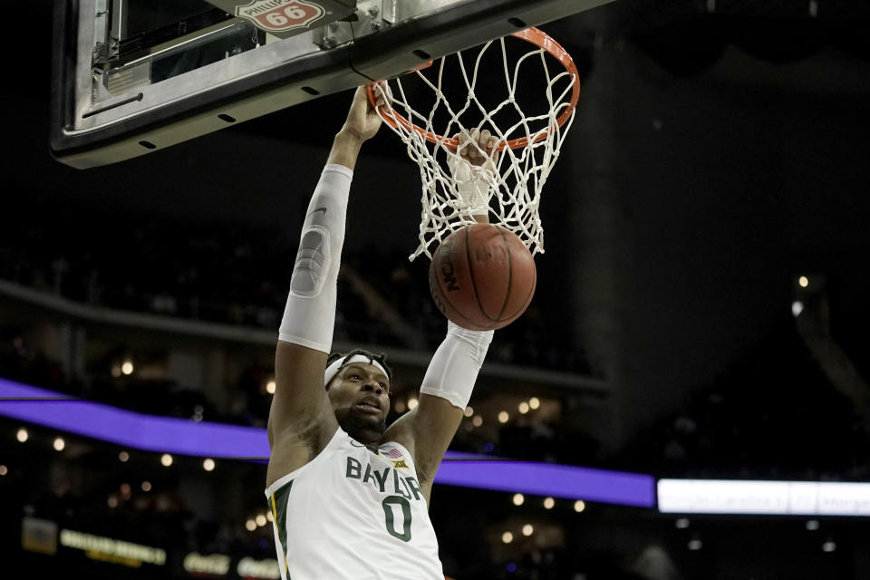 FILE - Baylor forward Flo Thamba dunks during the second half of the team's NCAA college basketball game against Oklahoma in the quarterfinals of the Big 12 tournament in Kansas City, Mo., March 10, 2022. While Baylor returnsonly two starters – guard Adam Flagler and big manThamba – the roster includes two guards coming back from injury, two Division I transfers and the league’s top incoming freshman. (AP Photo/Charlie Riedel, File)