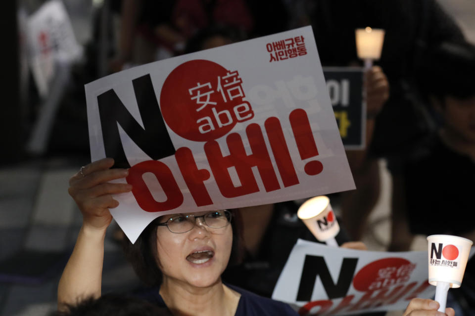 A South Korean protester reacts during a rally about the General Security of Military Information Agreement, or GSOMIA, in front of Japanese embassy in Seoul, South Korea, Thursday, Aug. 22, 2019. South Korea will stop exchanging classified intelligence on North Korea with Japan amid a bitter trade dispute, an official said Thursday, a surprise announcement that is likely to set back U.S. efforts to bolster security cooperation with two of its most important allies in the Asian region. The sign read "No Abe." (AP Photo/Lee Jin-man)