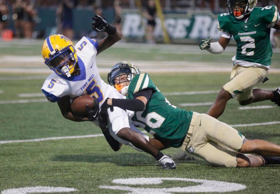 Catawba Ridge’s Tristian Swartzman (26), tackles Fort Mill’s Jeremiah McNeil in a 2023 game. The Fort Mill School District is a big reason people move to Fort Mill, and it’s gone from one high school to three in less than two decades to make room for all of them.