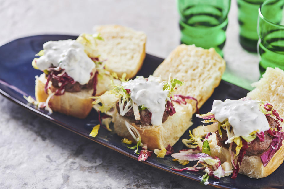 This April 2019 image shows a recipe for chipotle sliders with a colorful lettuce slaw and blue cheese dressing in New York. (Cheyenne Cohen via AP)